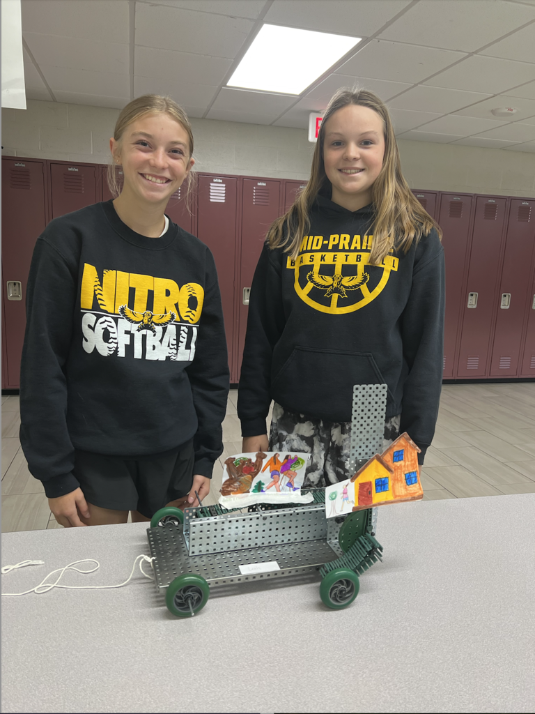 Students posing with pull toy project