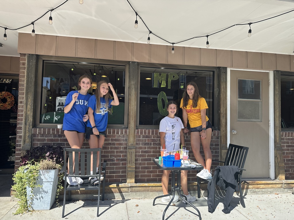 MPMS students painting coffee shop windows