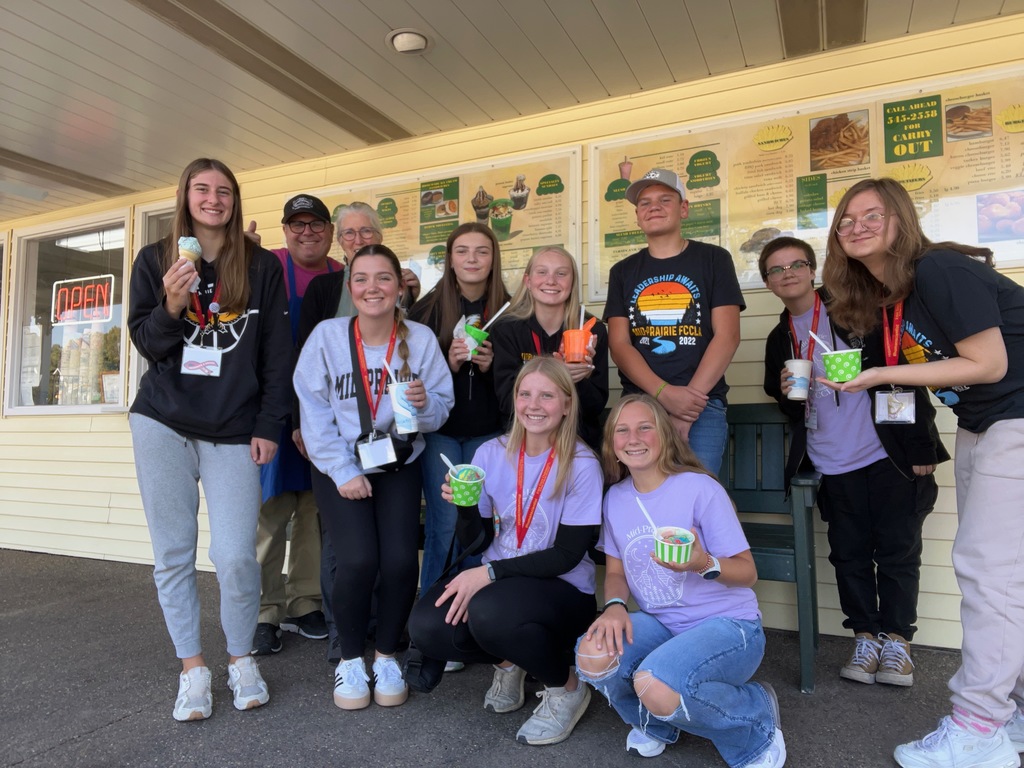 Students having ice cream with the owner of Jon's Ice Cream Shop in Tiffin, IA