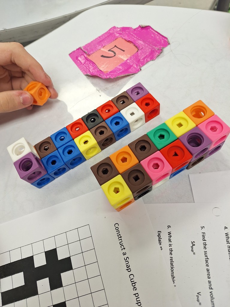 Students building with cubes