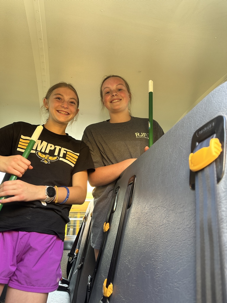 Students cleaning a bus