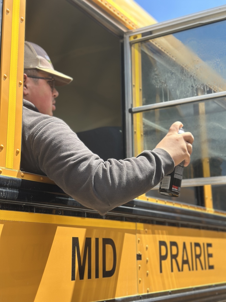 Student cleaning a bus