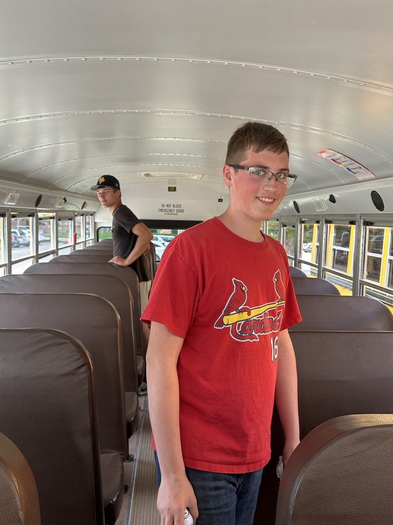 Students cleaning a bus