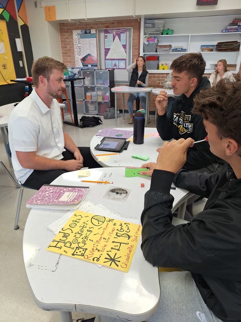 Students playing stats games with teachers