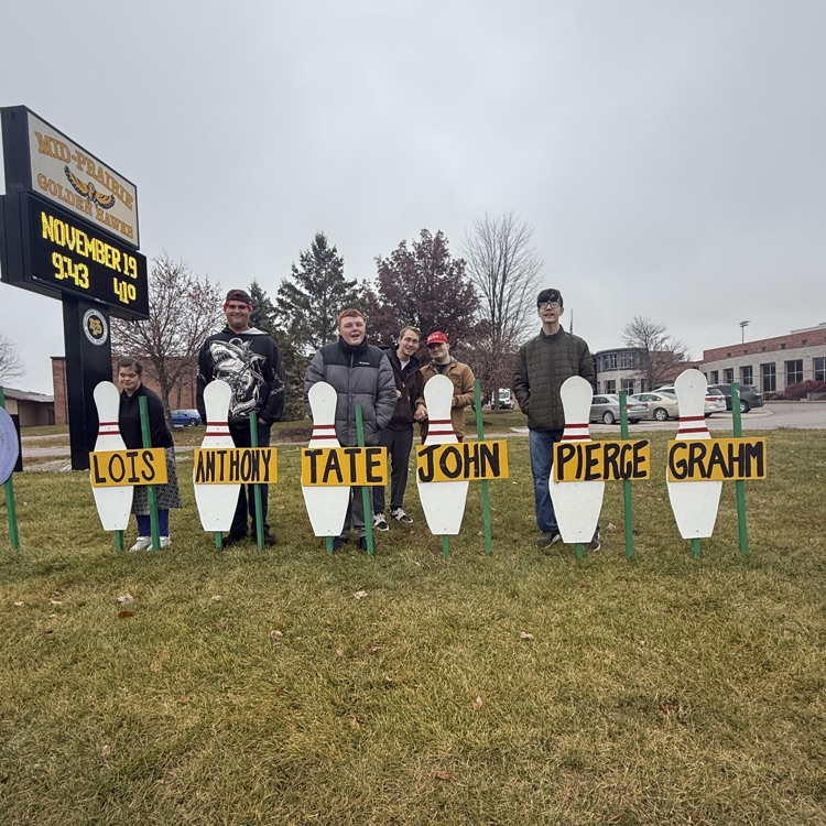 students with state bowling pin signs