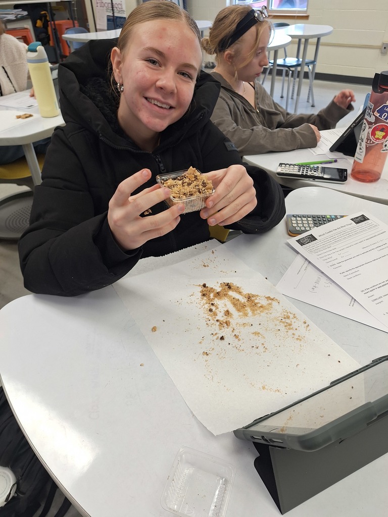 Student working with chocolate chip cookie