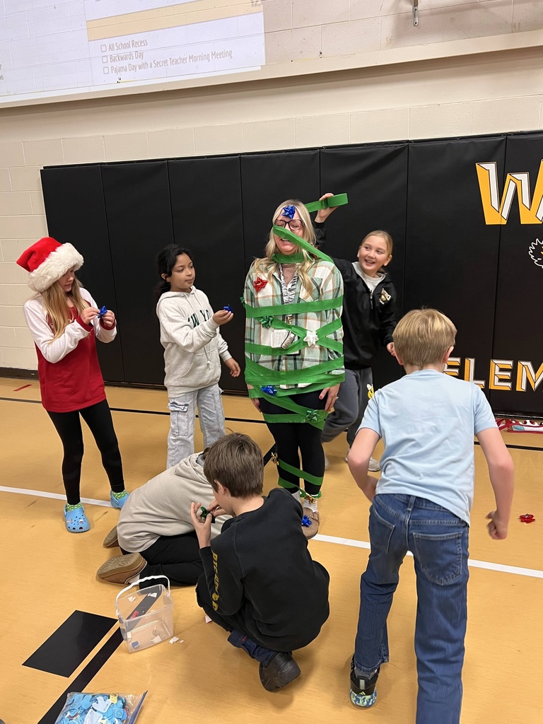 Students and staff member playing Christmas tree game