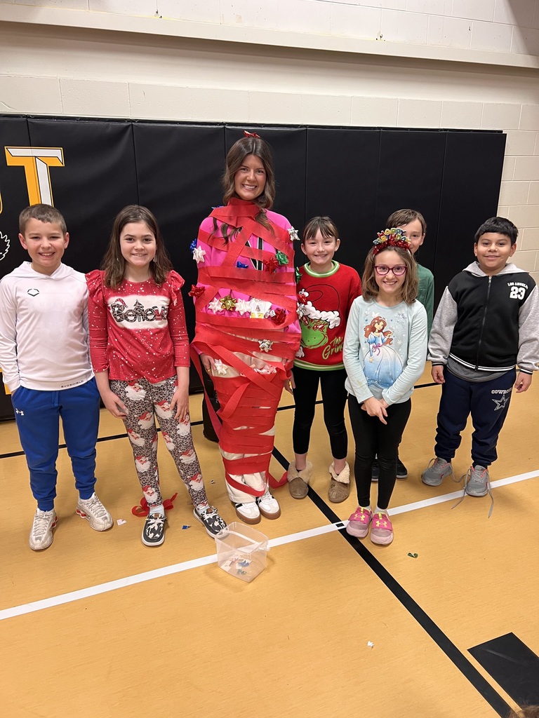 Students and staff member playing Christmas tree game