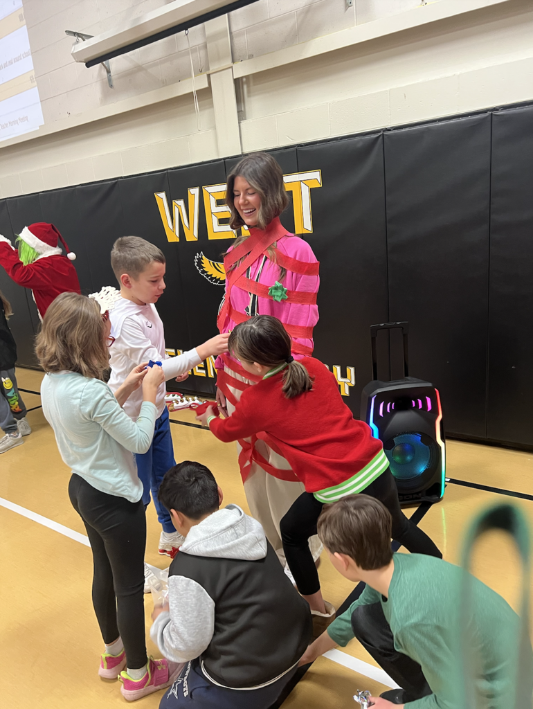 Students and staff member playing Christmas tree game