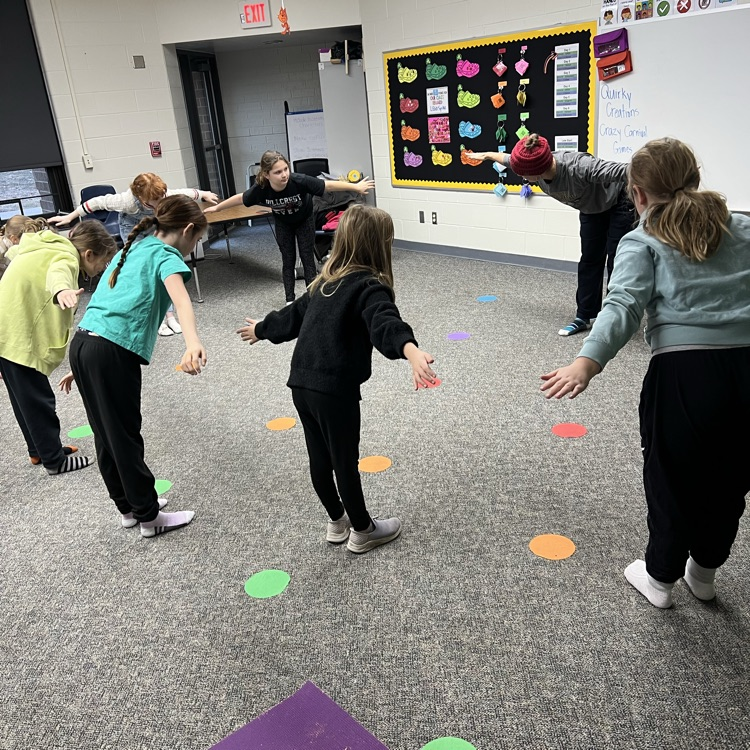 Elementary students doing yoga together
