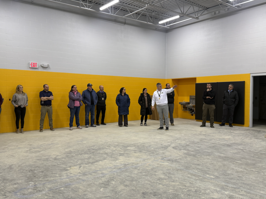Brian Stone showing the inside of the new activities building to facilities committee members