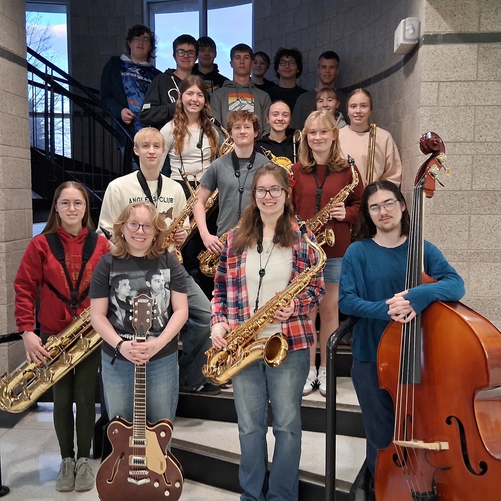 Group photo of the Mid-Prairie Golden Hawk Jazz Band students with instruments on the high school steps