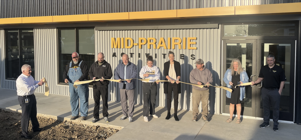 MP School Board members cutting the ribbon outside the Mid-Prairie Activities building
