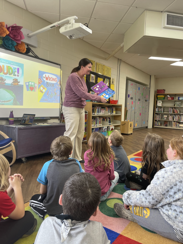 Sarah Puttmann reading a book to students