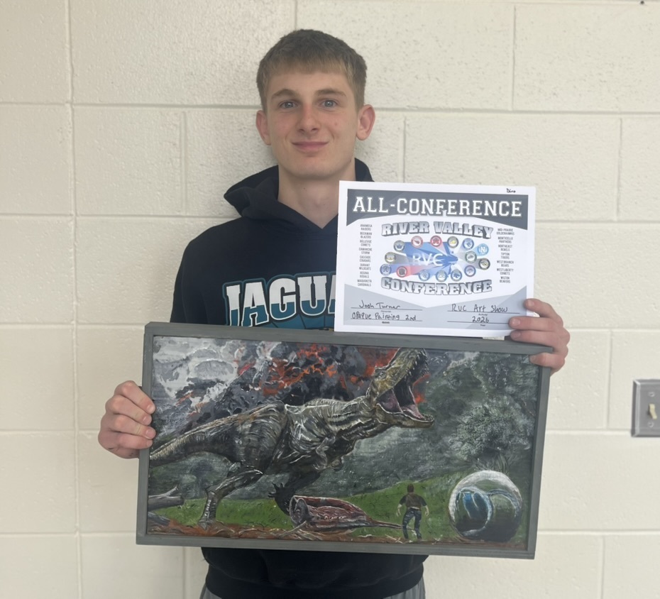 Josh Turner with his artwork of a dinosaur and his all-conference award