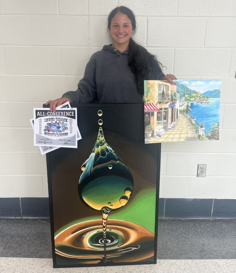 Sophie Miller with two of her artwork pieces, one of a water droplet and one of a boardwalk along a seaside, and her all-conference awards
