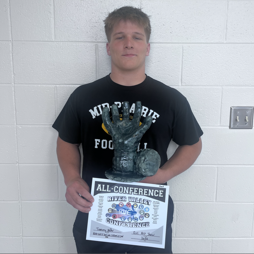 Tommy Miller with his artwork sculpture of a hand and his all-conference award