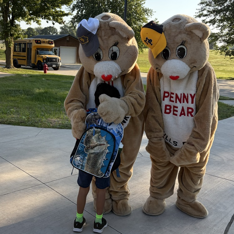 student hugging a bear. bear looking at student