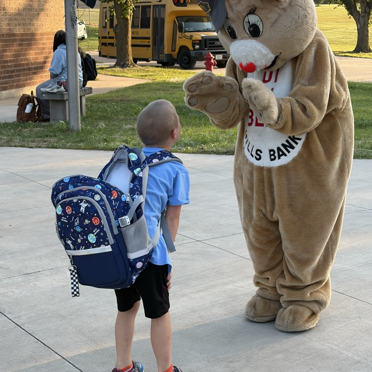 student looking at bear. bear showing its paws