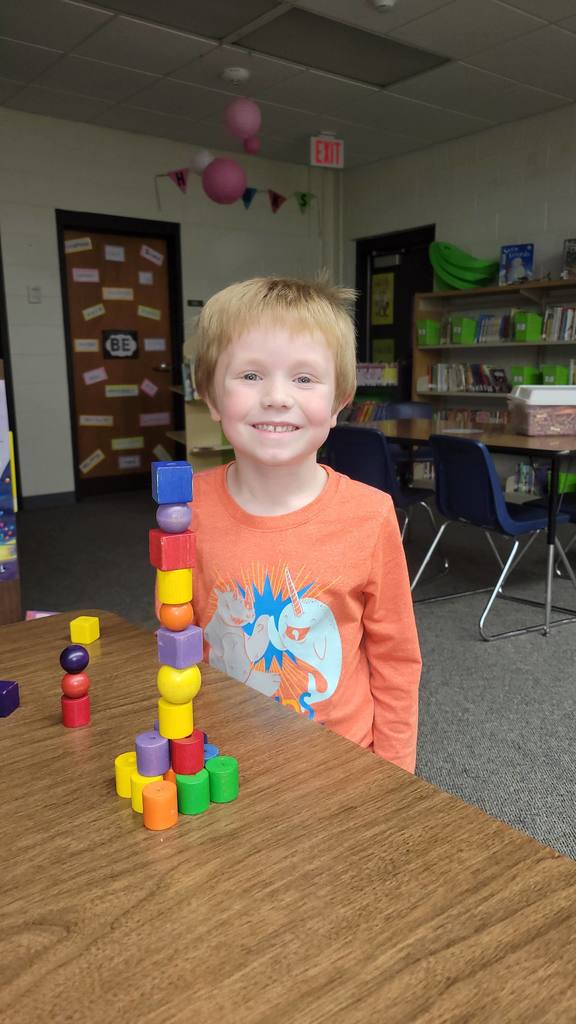 Student with a block tower he built