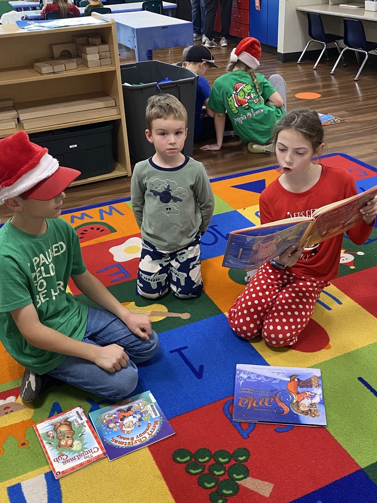 Students reading to younger students
