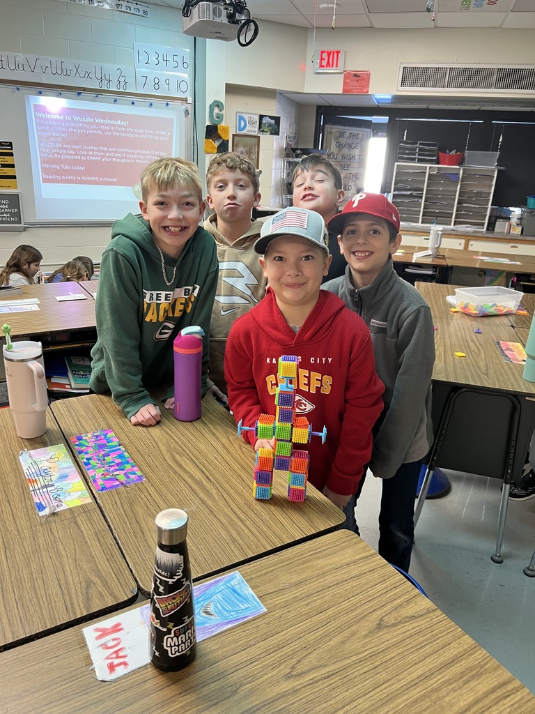 Students building with tiles at inside recess