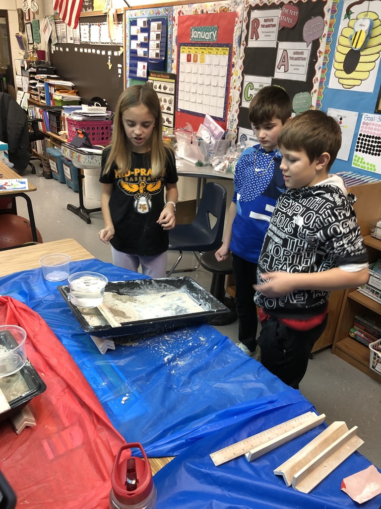 Students completing a science experiment in 4th grade