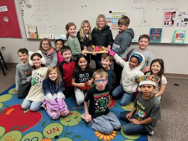 Mid-Prairie students celebrating with cake in Spanish class
