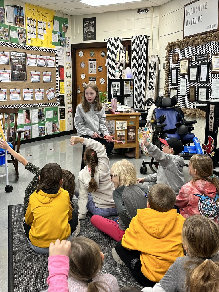 Mid-Prairie student reading aloud to 