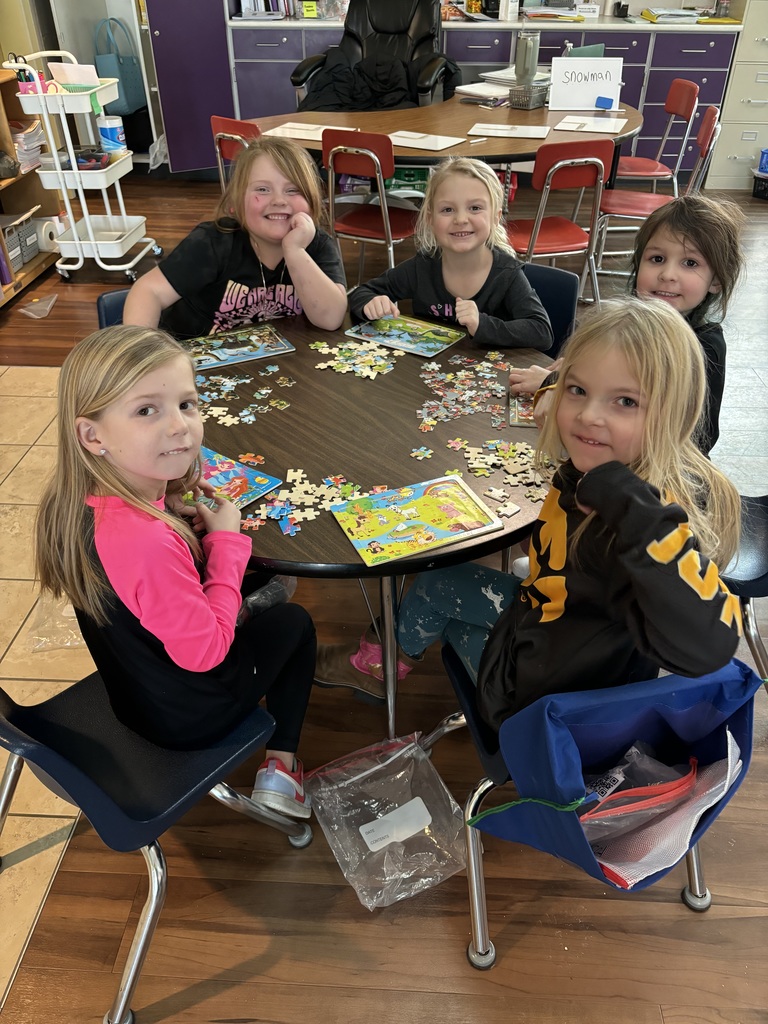 Mid-Prairie kindergarten students doing puzzles for inside recess