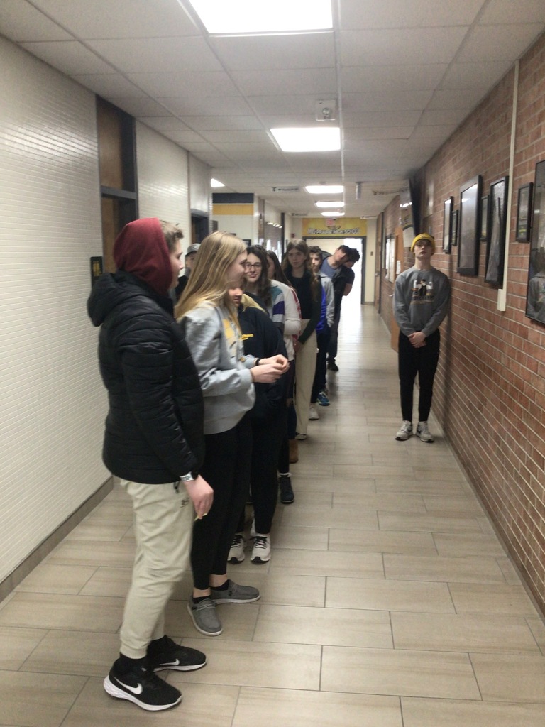 Mid-Prairie Geometry students creating a perpendicular bisector in the hallway