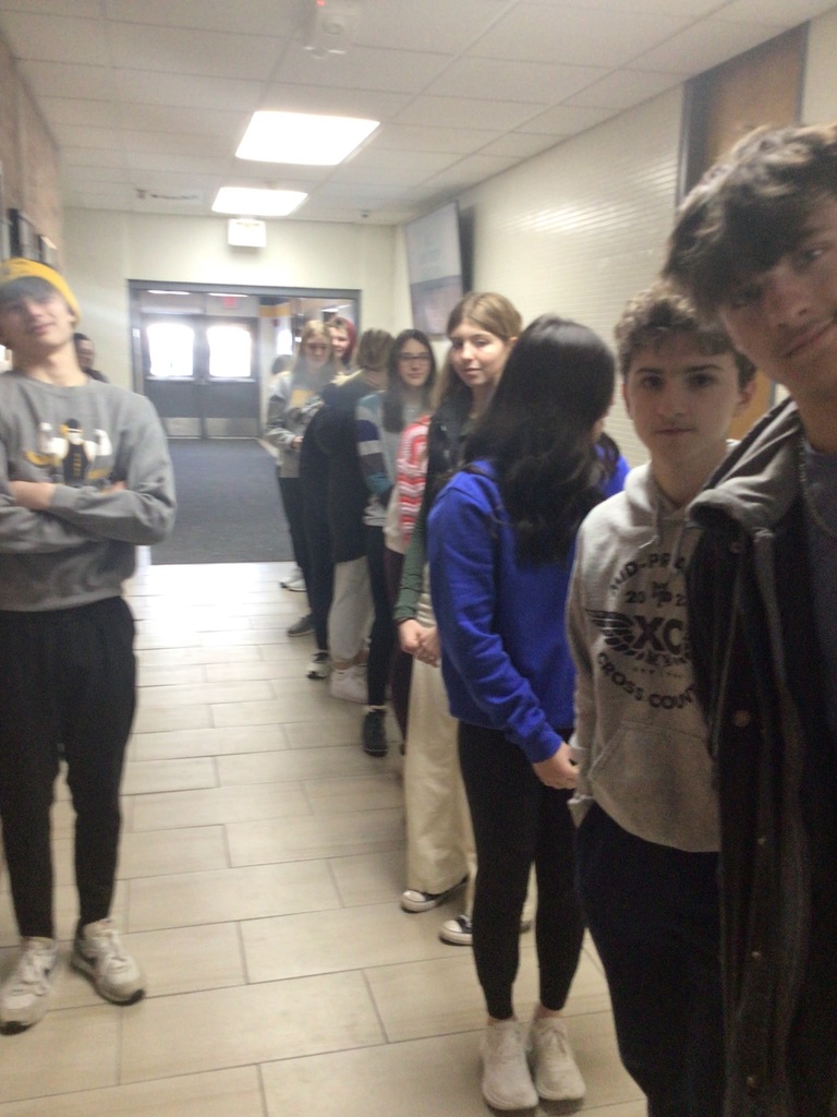 Mid-Prairie Geometry students creating a perpendicular bisector in the hallway