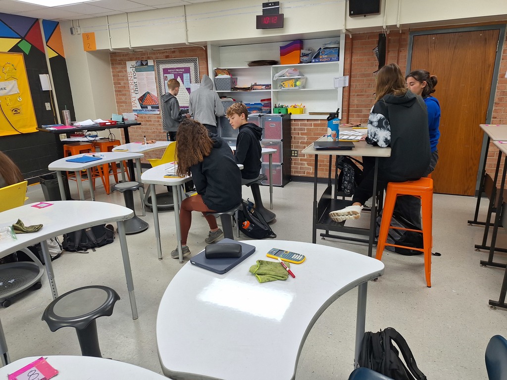 Algebra students working through game-style equations