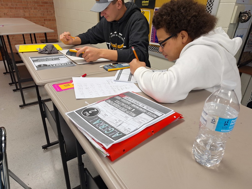 Algebra students working through game-style equations