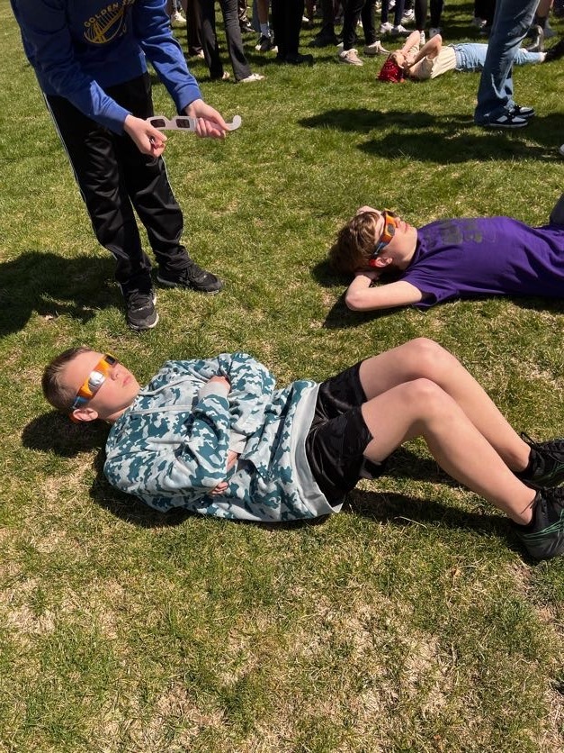 Students using eclipse classes to look at 4/8/24 eclipse