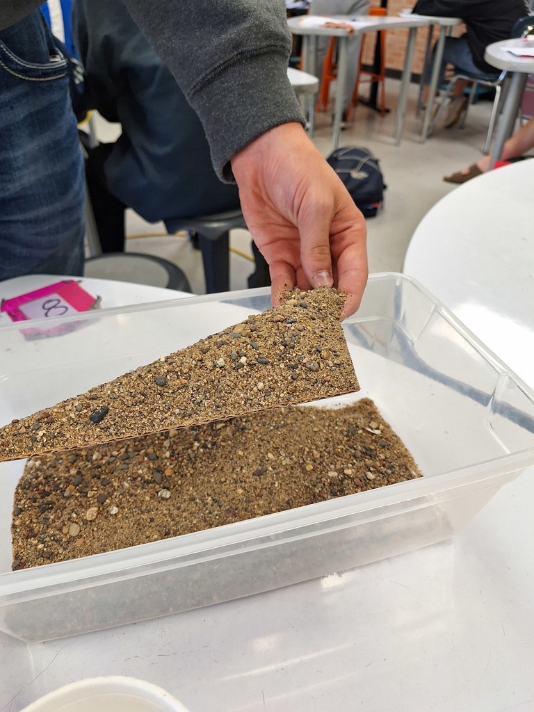 Triangle with sand piled on top for geometry lesson