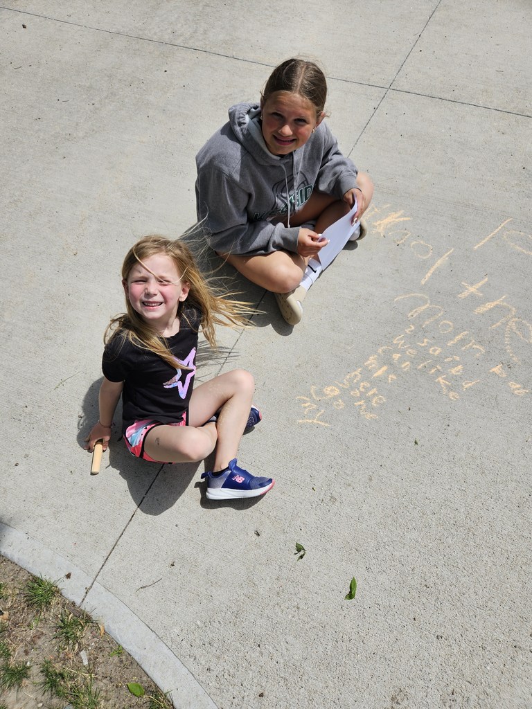 Students writing sight words in sidewalk chalk