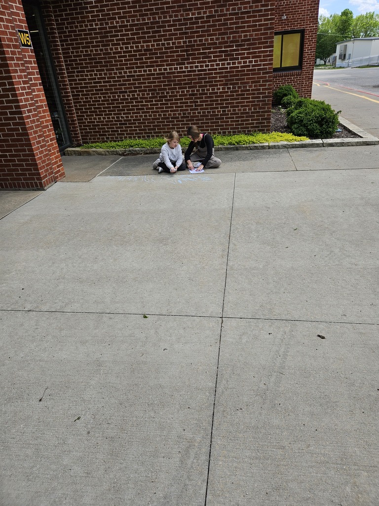 Students writing sight words in sidewalk chalk