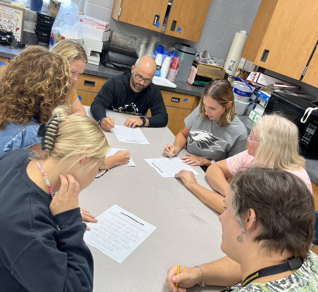 Teams working on solving a coded message