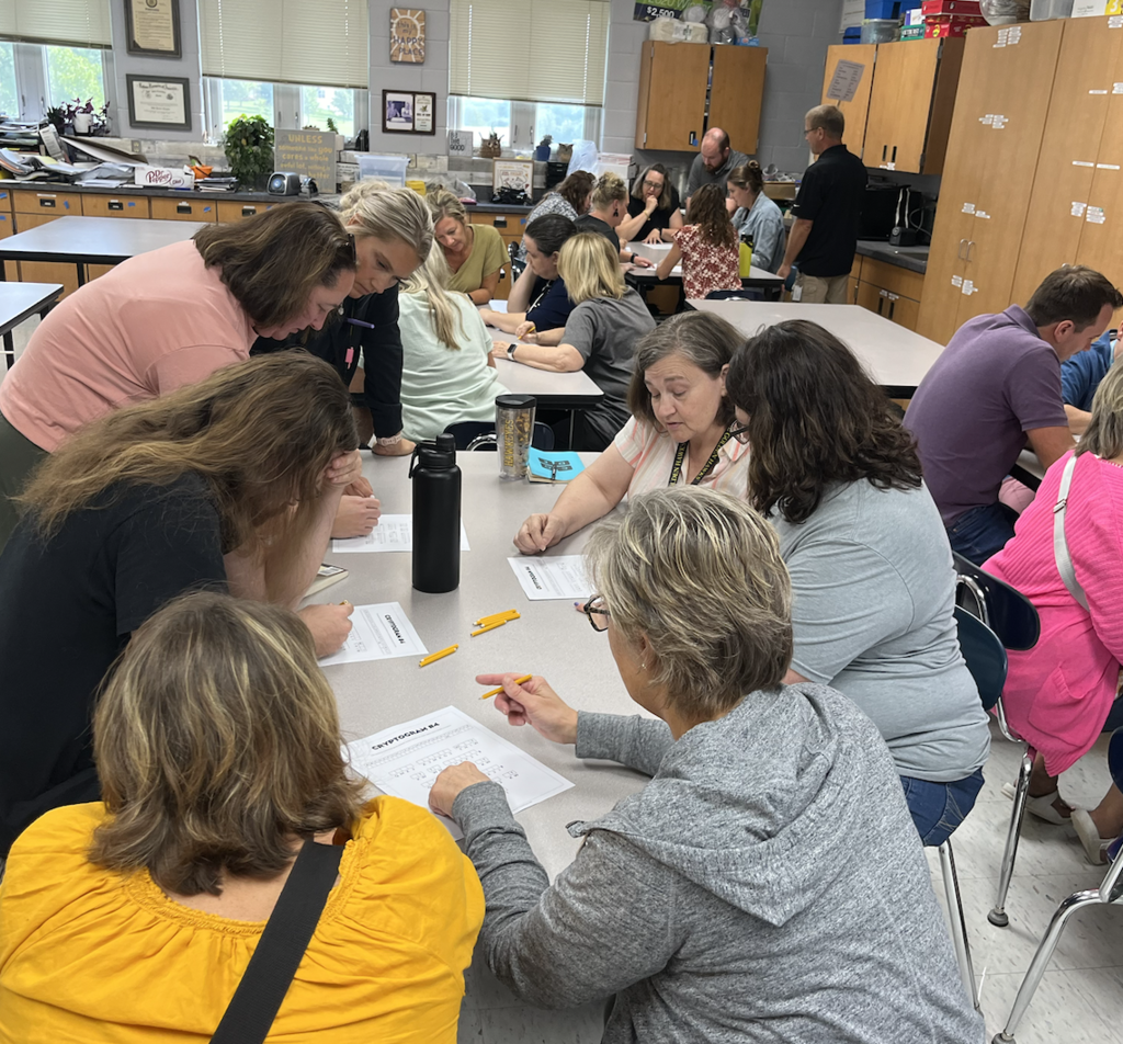 Teams working on solving a coded message
