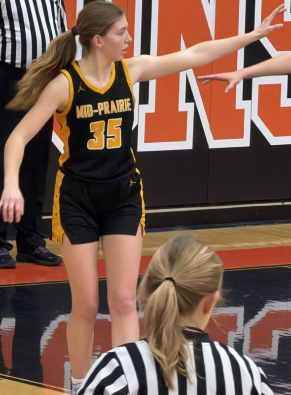 female Student in MP basketball uniform running on the court