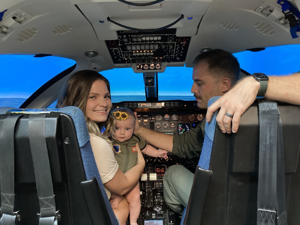 Photo of Allison and her daughter her husband inside the plane