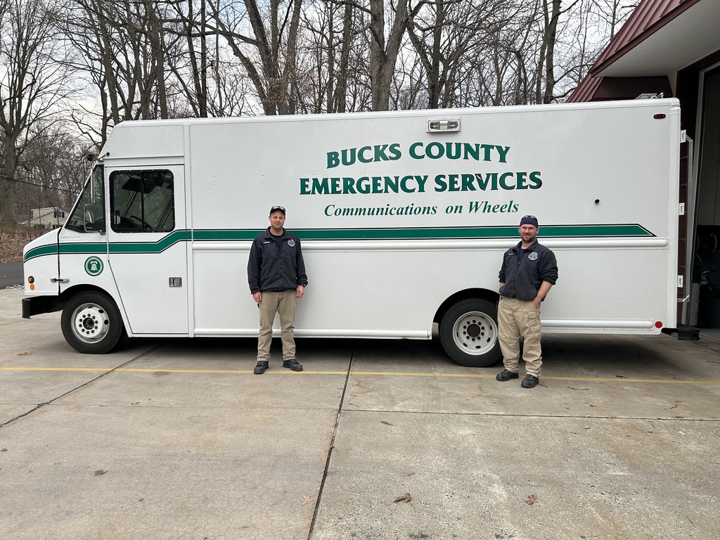 There's a picture of AJ and Anthony standing in front of Bucks County emergency large truck van box white van