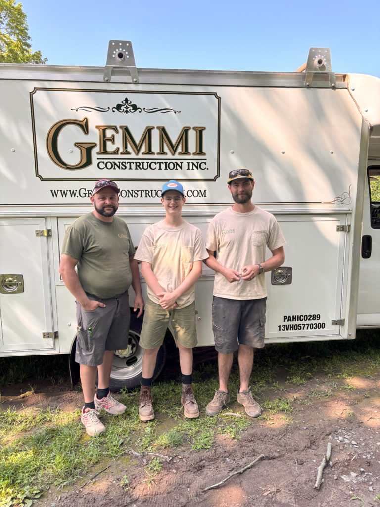 It's a picture of Chase with his father and Ross in front of it jimmy Construction Incorporated white box truck