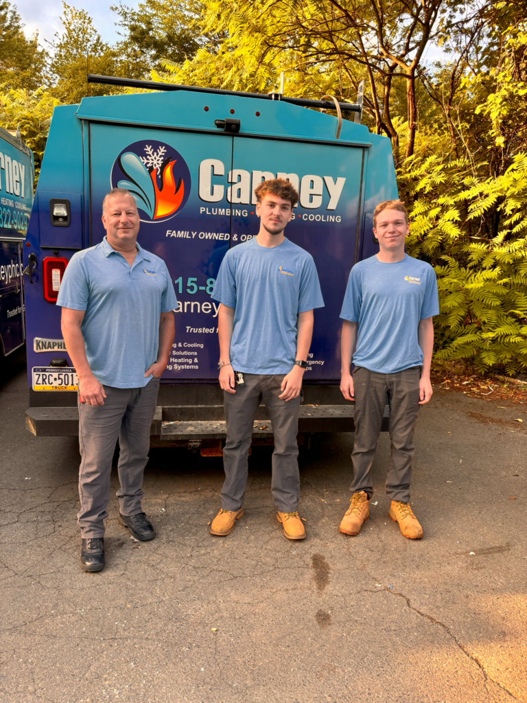 this Fisher of brody and caleb along with one of their mentors from carney all seasons in front of a blue truck of a blue work truck all three of them are wearing their blue work shirts along with their work pants