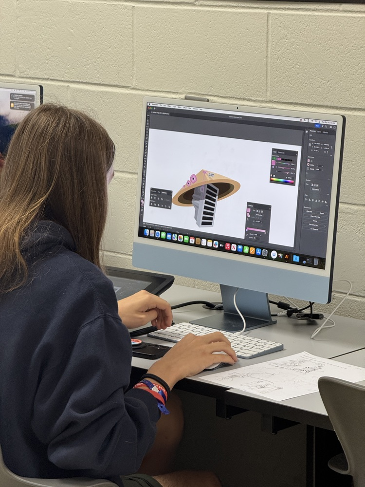Picture of student sitting at her desk working on a computer