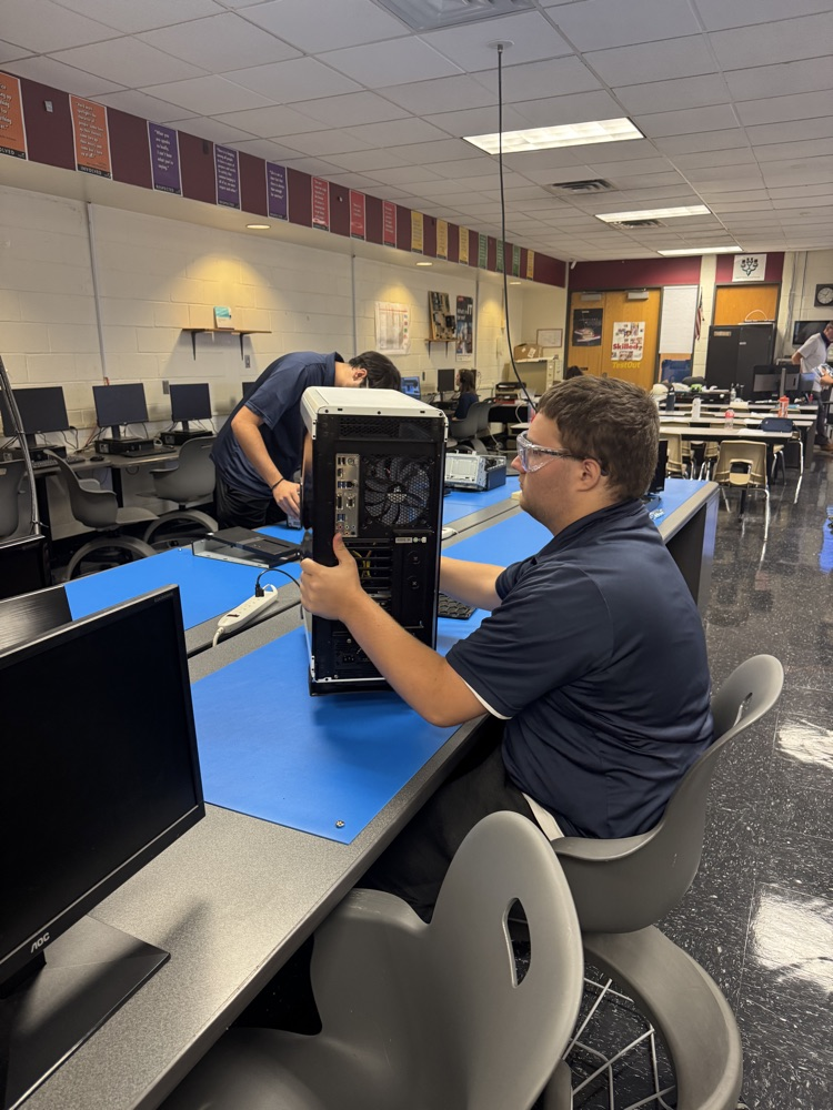 student working on a computer with safety glasses on