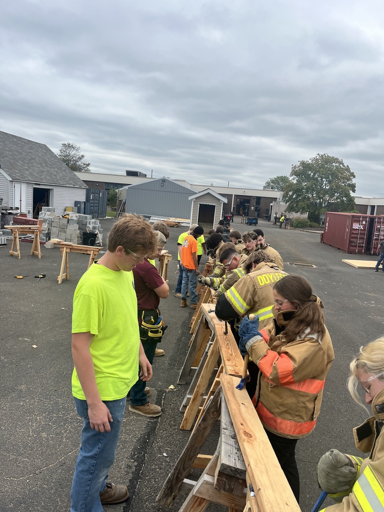 This is a photo of the carpentry students working with public safety students on Saul horses public safety students are here working with a hammer and it's a