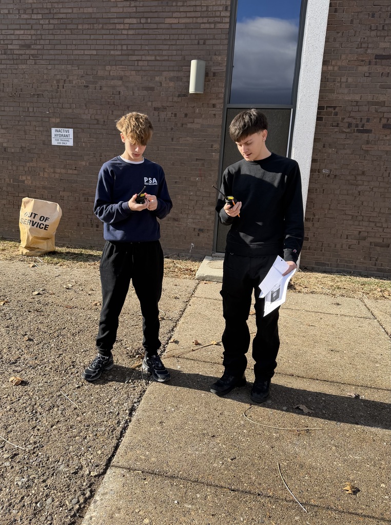 Two public safety students working with communication devices.