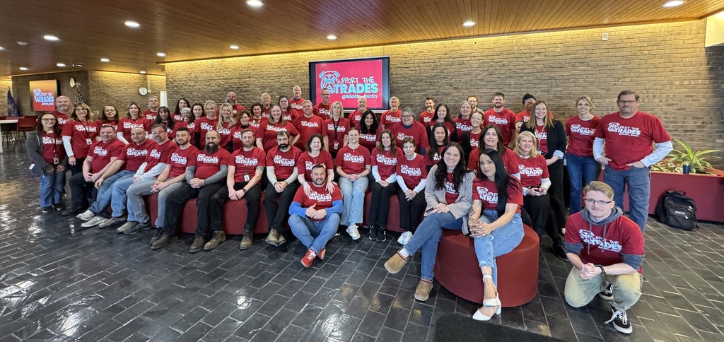Aaj Ki photo of all the staff wearing the red support the trade T shirts